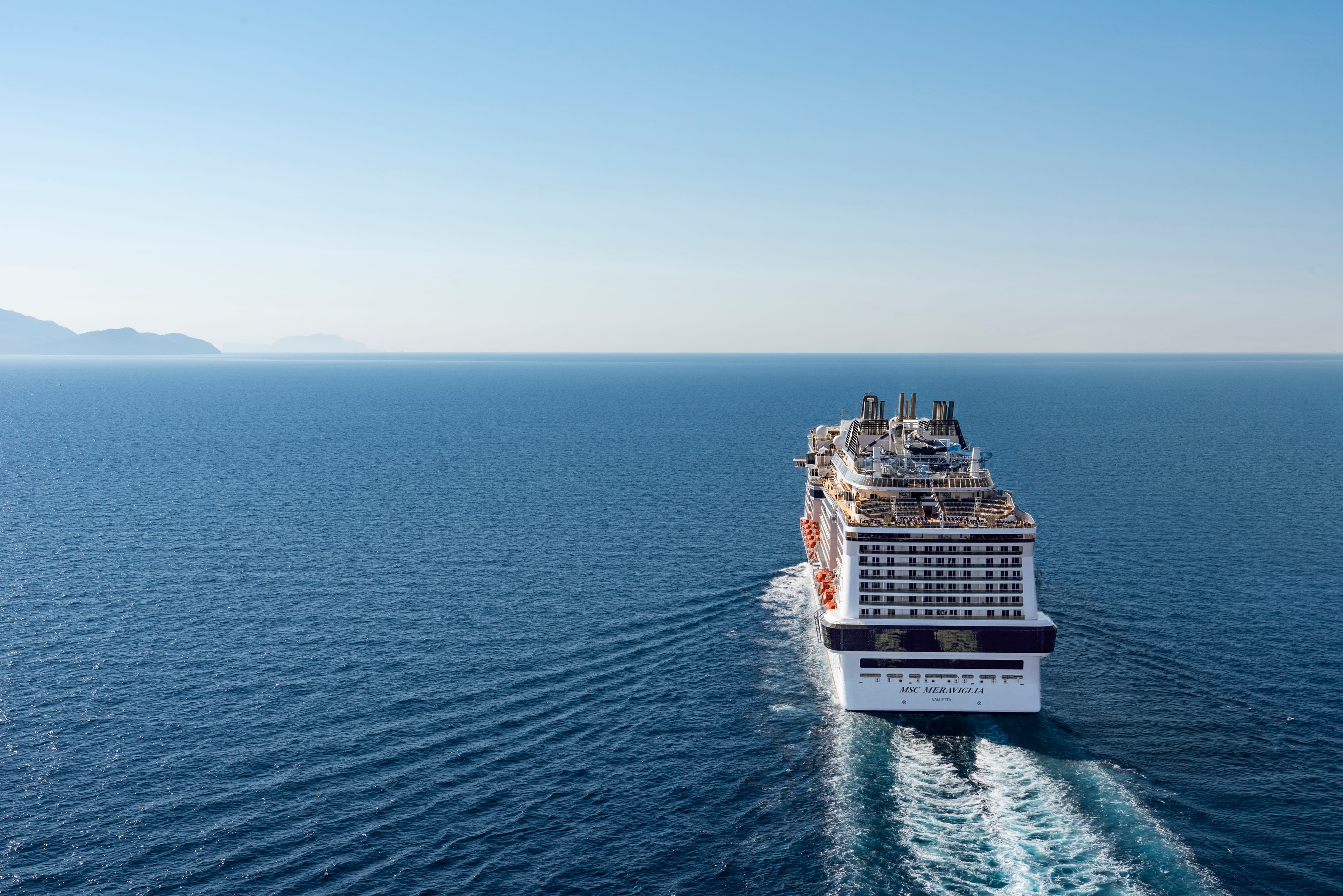 MSC Meraviglia aft aerial underway under a clear sky