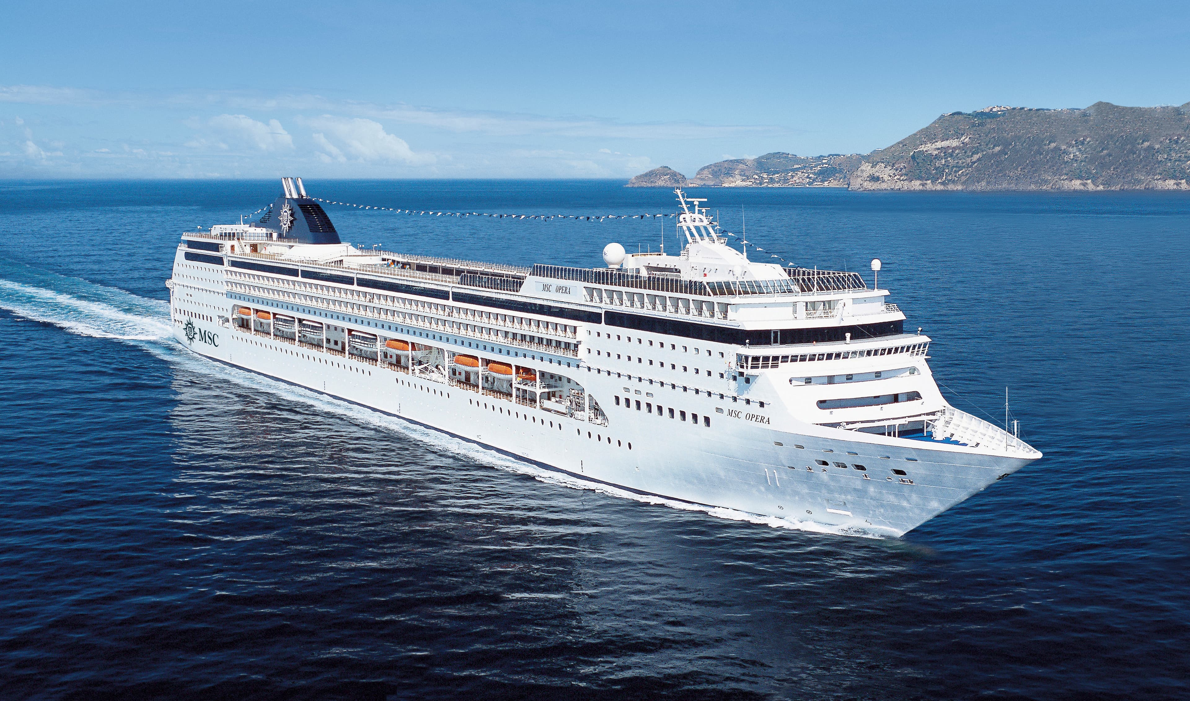 MSC Opera sailing at sea under clear midday sky