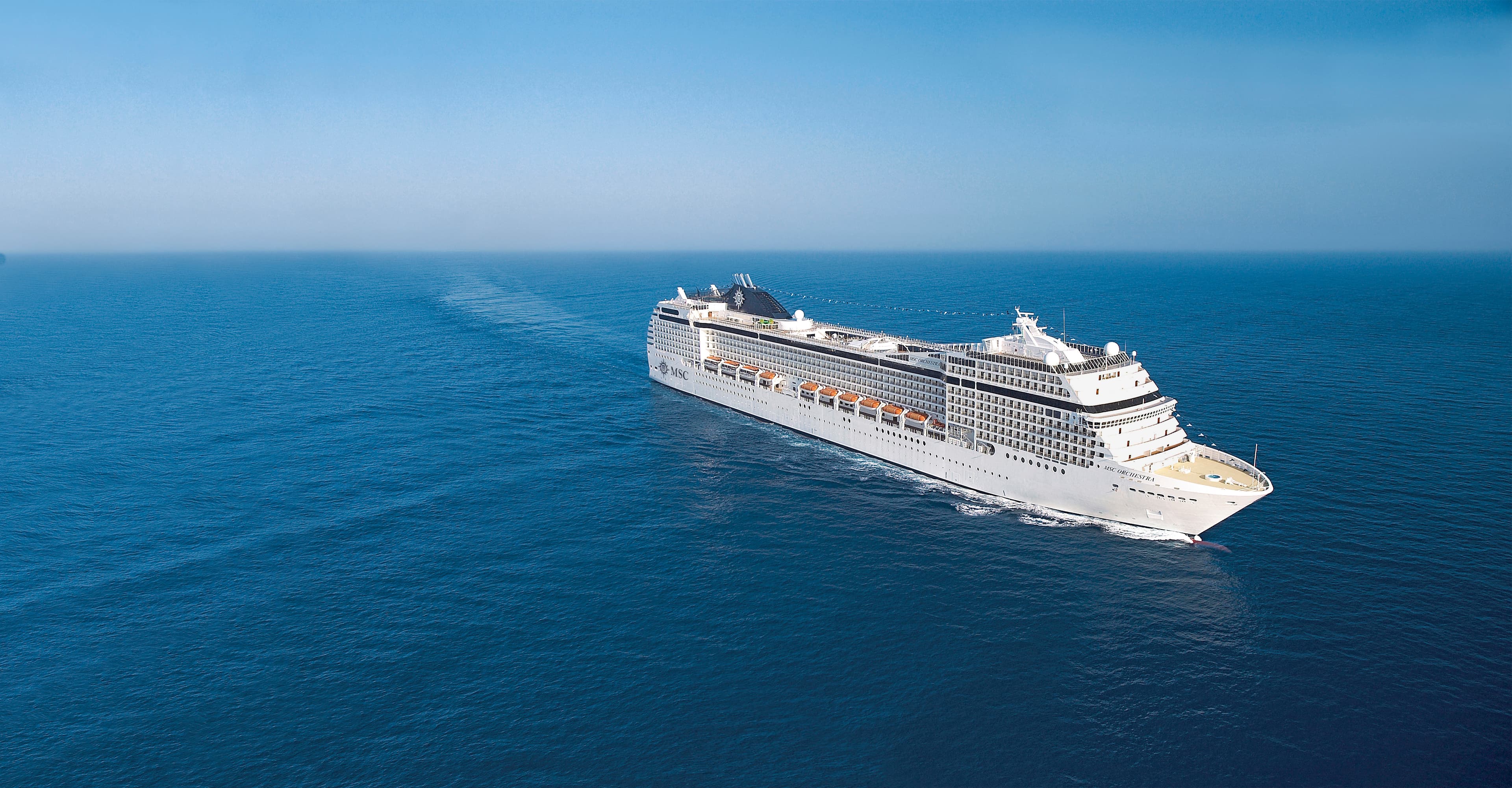 MSC Orchestra sailing at sea under clear midday sky