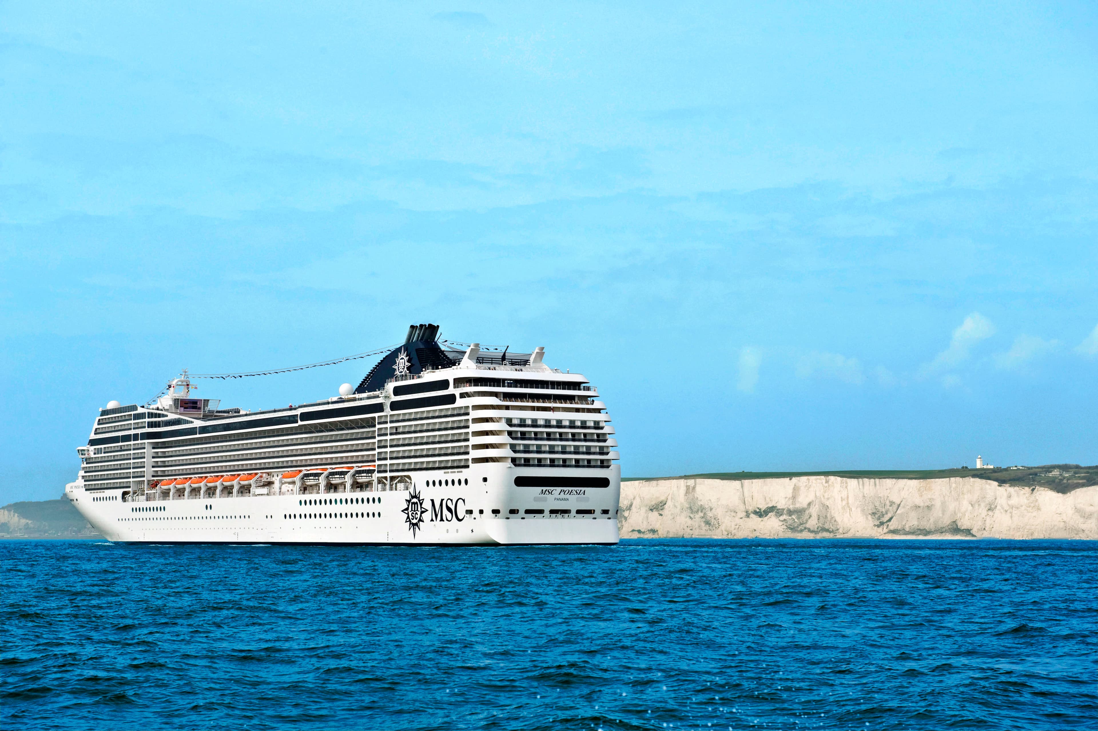 MSC Poesia sunny stern exterior at sea with White Cliffs behind
