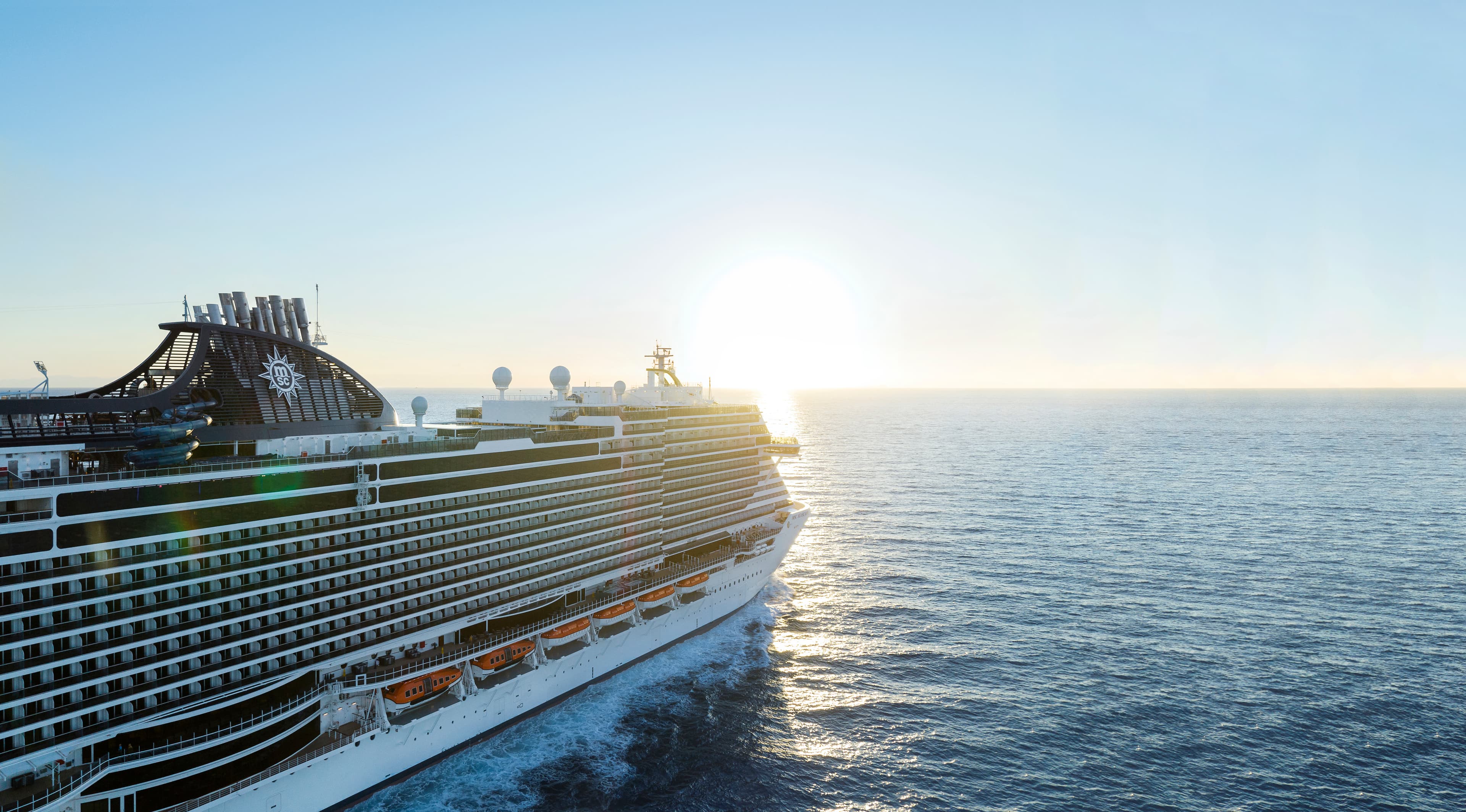 MSC Seascape aerial underway with sun on the horizon