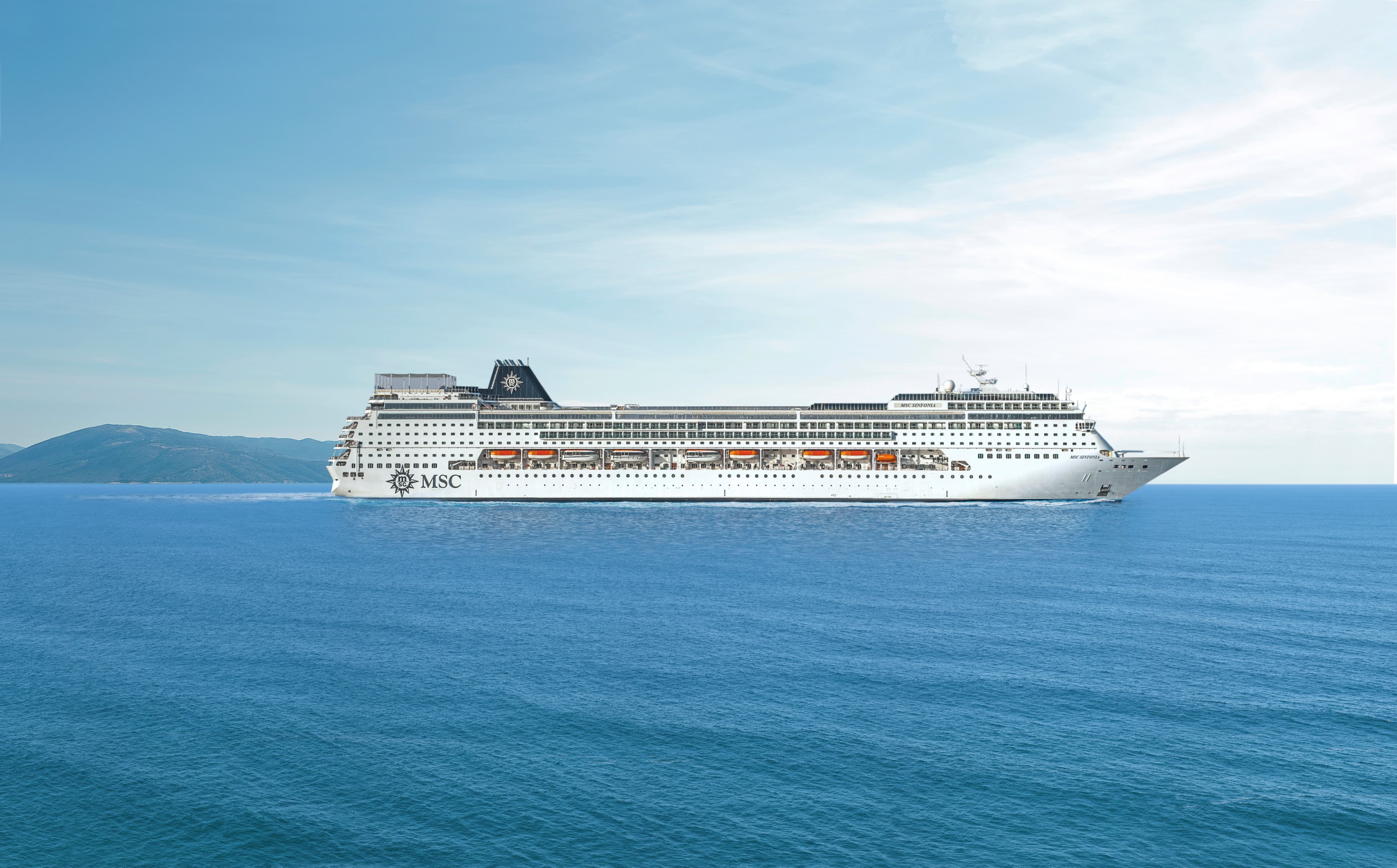 MSC Sinfonia sailing at sea under clear midday sky